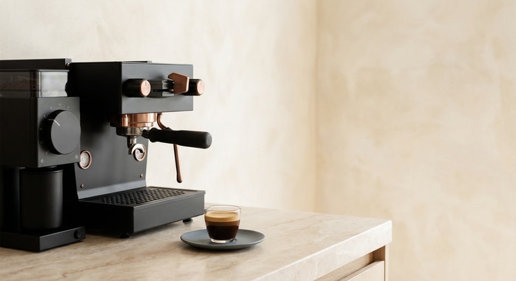 A single espresso shot on a clean marble countertop in soft morning light